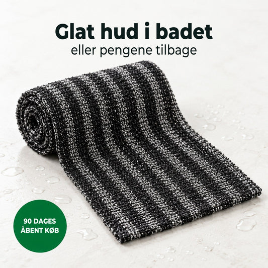 Soldahl Glatro eksfolierende brusehåndklæde i sort, rullet sammen med vanddråber